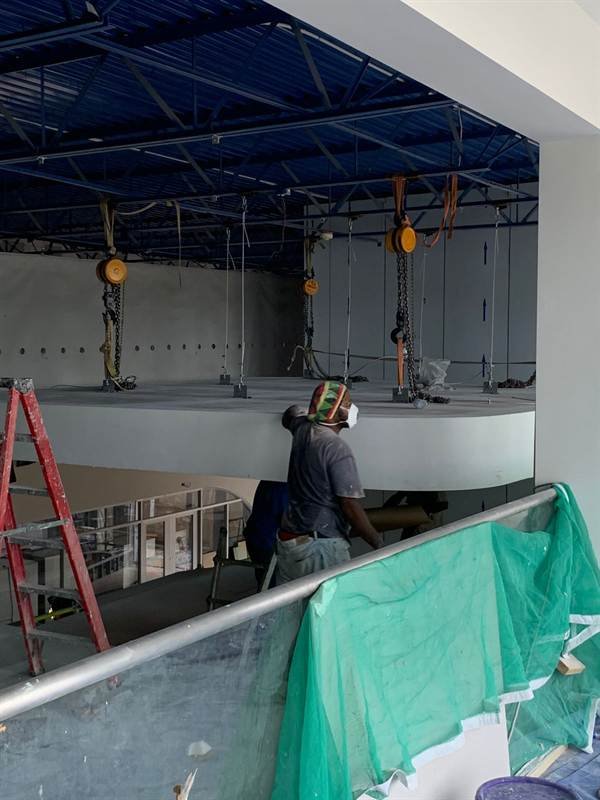 Worker rigging chain hoists on the ceiling at BYD, ATL Complex, Montego Bay
