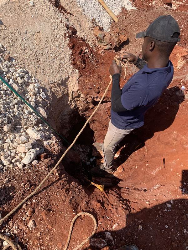 Worker setting a utility pole for the NIC EVAD water project