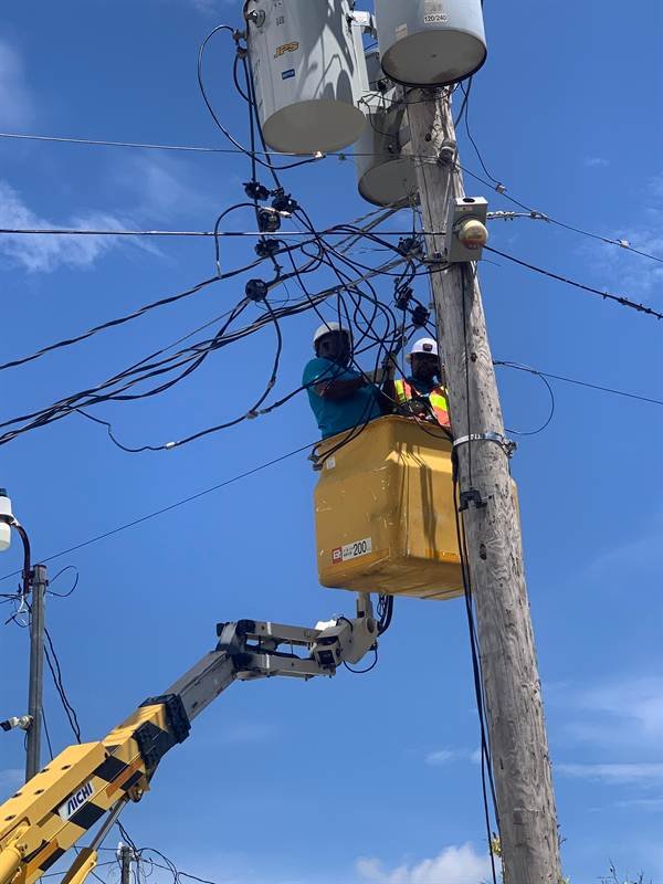 Bucket truck crew working on pole-top transformers at Oil Factory, Clarendon