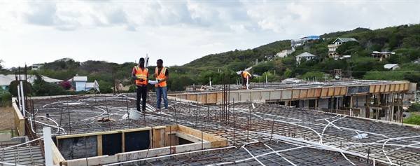 Engineers reviewing rooftop electrical conduit rough-in